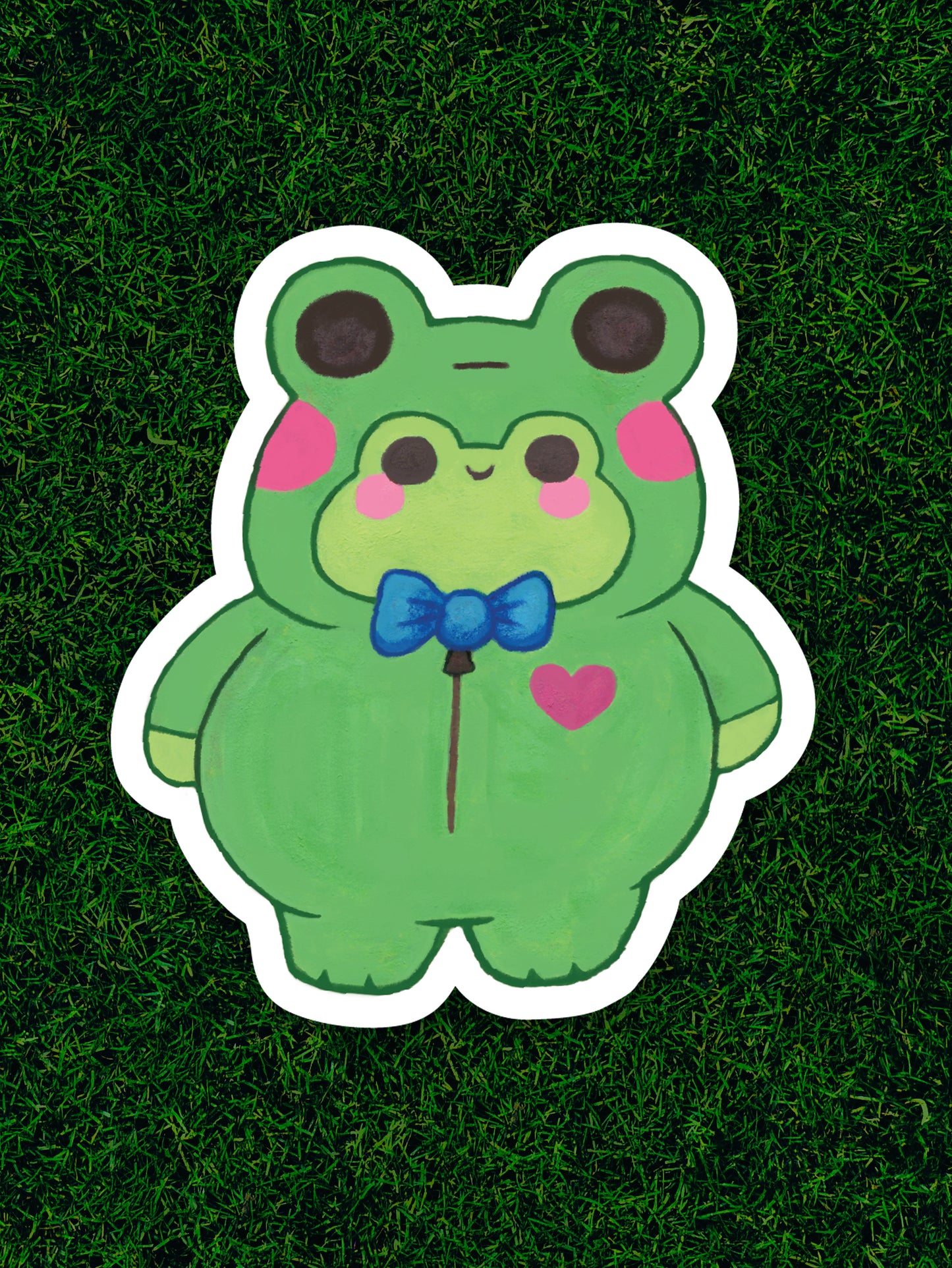 Cartoon frog character with a bow tie on a grass background