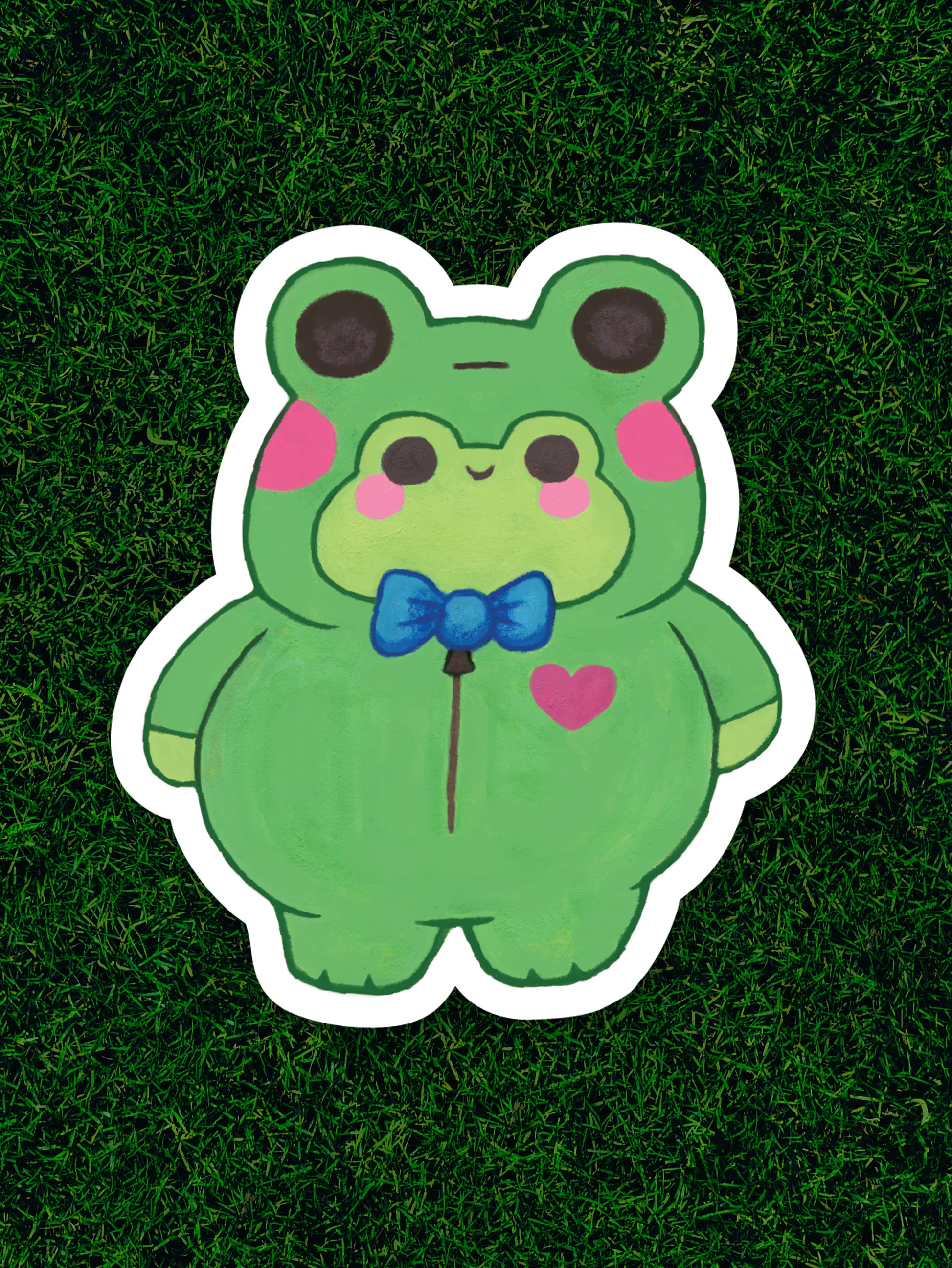 Cartoon frog character with a bow tie on a grass background