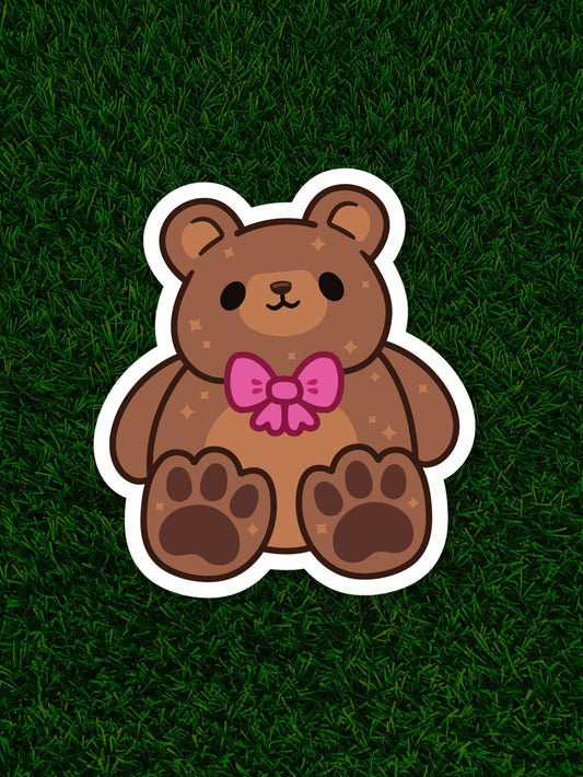 Cartoon bear with a pink bow on a grassy background